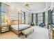 Bright main bedroom featuring a king-size bed, sitting area, and elegant window treatments at 12310 Stonelake Ranch Blvd, Thonotosassa, FL 33592