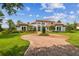 Luxury home with circular brick driveway and Mediterranean style architecture at 12310 Stonelake Ranch Blvd, Thonotosassa, FL 33592