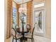 Charming breakfast nook with a round table and chairs, overlooking the pool at 12310 Stonelake Ranch Blvd, Thonotosassa, FL 33592
