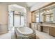 Luxurious bathroom featuring a large soaking tub, double vanities, and a walk-in shower at 12310 Stonelake Ranch Blvd, Thonotosassa, FL 33592