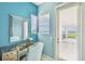 Vanity area with a mirror and chair, offering a view of the patio and lake at 12310 Stonelake Ranch Blvd, Thonotosassa, FL 33592