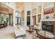 Spacious living room with high ceilings, fireplace, and access to the backyard at 12310 Stonelake Ranch Blvd, Thonotosassa, FL 33592