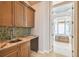 Elegant bathroom with wet bar, granite countertops, and a large soaking tub at 12310 Stonelake Ranch Blvd, Thonotosassa, FL 33592