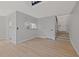 Living area with light walls, hardwood floors, and a kitchen pass-through at 12411 Titus Ct # 12411, Tampa, FL 33612