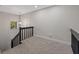 Open loft space with carpet and view of the staircase at 12411 Titus Ct # 12411, Tampa, FL 33612