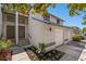 Two-story townhouse with a white garage door and landscaping at 12411 Titus Ct # 12411, Tampa, FL 33612
