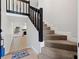 Modern staircase with black railings and carpeted steps at 12411 Titus Ct # 12411, Tampa, FL 33612