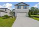 Two-story house with light beige siding, blue shutters, and a two-car garage at 10624 Hidden Banks Gln, Parrish, FL 34219