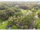 Aerial image showing a residential property surrounded by lush trees at 7207 Westinghouse Ave, Tampa, FL 33619