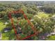 Vacant lot surrounded by mature trees and residential properties at 7207 Westinghouse Ave, Tampa, FL 33619
