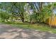 Residential lot with mature trees, and a home visible in the background at 7207 Westinghouse Ave, Tampa, FL 33619