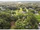 Aerial view of residential property showing house and lot with surrounding trees at 7207 Westinghouse Ave, Tampa, FL 33619
