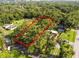 Overgrown lot ready for new construction, surrounded by established homes at 7207 Westinghouse Ave, Tampa, FL 33619