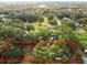 Aerial view of vacant lot, surrounded by lush trees and residential homes at 7207 Westinghouse Ave, Tampa, FL 33619