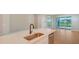 Kitchen island with quartz countertop and stainless steel sink, opens to backyard at 12706 Palatka Dr, Venice, FL 34293
