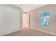 Bedroom with carpet, window, and built-in closet at 12706 Palatka Dr, Venice, FL 34293