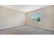 Bright bedroom with neutral walls and carpet flooring, large window with view at 12706 Palatka Dr, Venice, FL 34293