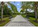 Relaxing walkway with benches, lined with palm trees at 12706 Palatka Dr, Venice, FL 34293