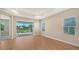Spacious bedroom with wood floors and access to a screened patio with water view at 12706 Palatka Dr, Venice, FL 34293