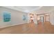 Living room with wood floors and open kitchen view at 12706 Palatka Dr, Venice, FL 34293