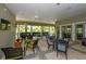 Relaxing community patio with tables, chairs, and a view of lush landscaping at 12706 Palatka Dr, Venice, FL 34293