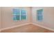 Bright bedroom with wood floors and two windows at 12706 Palatka Dr, Venice, FL 34293