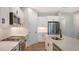 Modern kitchen features white cabinets, stainless steel appliances, and quartz countertops at 12706 Palatka Dr, Venice, FL 34293