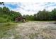 Rustic cabin on a partially cleared lot with mature trees at 7813 Valrie Ln, Riverview, FL 33569