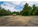Wooded lot with a small cabin, showing potential for new construction at 7813 Valrie Ln, Riverview, FL 33569