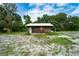 Rustic cabin on a partially cleared lot with mature trees at 7813 Valrie Ln, Riverview, FL 33569