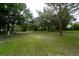 Property yard with mature trees and grassy areas at 7813 Valrie Ln, Riverview, FL 33569