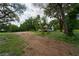 Vacant lot with house in background, mature trees at 7813 Valrie Ln, Riverview, FL 33569