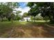 White house exterior with mature trees in the background at 7813 Valrie Ln, Riverview, FL 33569