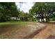Property yard with mature trees and grassy areas at 7813 Valrie Ln, Riverview, FL 33569