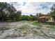 Partially cleared lot with mature trees and a small cabin at 7813 Valrie Ln, Riverview, FL 33569
