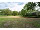 Property yard with mature trees, shed and fence at 7813 Valrie Ln, Riverview, FL 33569