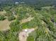 Aerial view of property with a small shed on a wooded lot at 7813 Valrie Ln, Riverview, FL 33569