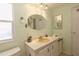 Bathroom with single vanity and oval mirror at 107 E Saint Johns Way, Apollo Beach, FL 33572