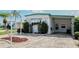 A charming single-story home with covered parking and a well-manicured front yard and decorative landscaping at 107 E Saint Johns Way, Apollo Beach, FL 33572
