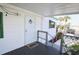 Covered front porch with access ramp and decorative railing at 107 E Saint Johns Way, Apollo Beach, FL 33572