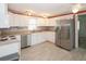 Kitchen with white cabinets, stainless steel appliances, and wood-look floors at 107 E Saint Johns Way, Apollo Beach, FL 33572