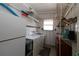 Laundry room with washer, dryer, and ample shelving at 107 E Saint Johns Way, Apollo Beach, FL 33572