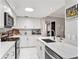 Modern white kitchen with quartz countertops and stainless steel appliances at 4141 Bayshore Blvd # 1203, Tampa, FL 33611