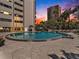 Refreshing circular pool with surrounding patio and lounge chairs at 4141 Bayshore Blvd # 1203, Tampa, FL 33611