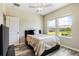 Well-lit bedroom with a double bed and large window at 31807 Blue Passing Loop, Wesley Chapel, FL 33545