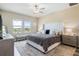 Bright bedroom with a king-size bed, plush carpet, and plenty of natural light at 31807 Blue Passing Loop, Wesley Chapel, FL 33545