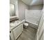 Clean bathroom with a tub and white vanity at 8353 Normandy Dr, Weeki Wachee, FL 34613