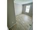 Simple bedroom with wood-look flooring and a window at 8353 Normandy Dr, Weeki Wachee, FL 34613
