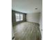 Spacious bedroom with wood-look flooring and large windows at 8353 Normandy Dr, Weeki Wachee, FL 34613