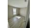 Bright bedroom featuring wood-look flooring and a window at 8353 Normandy Dr, Weeki Wachee, FL 34613